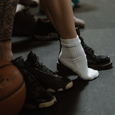 Close-up of athletic shoes on a gym floor.