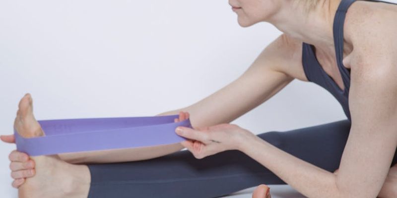 Side view of a person stretching after a workout.
